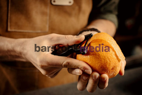 Bartender Peeling Oranges for Garnish