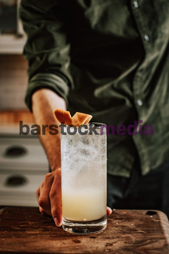 Home Bartender Serving Collins