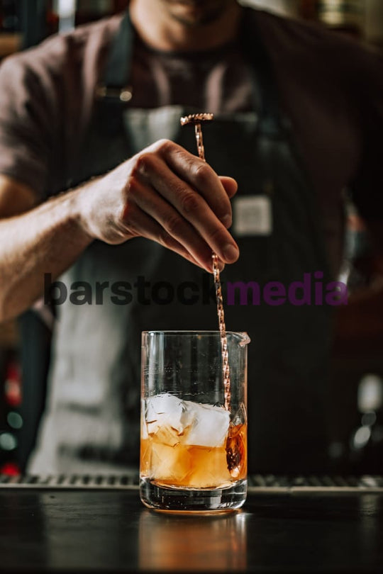 Bartender Stirring Cocktail on Bar