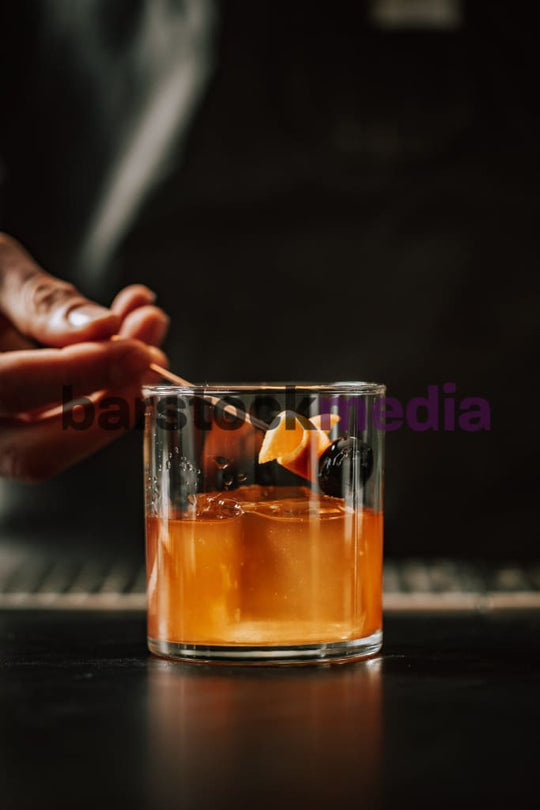 Bartender Garnishing Old Fashioned