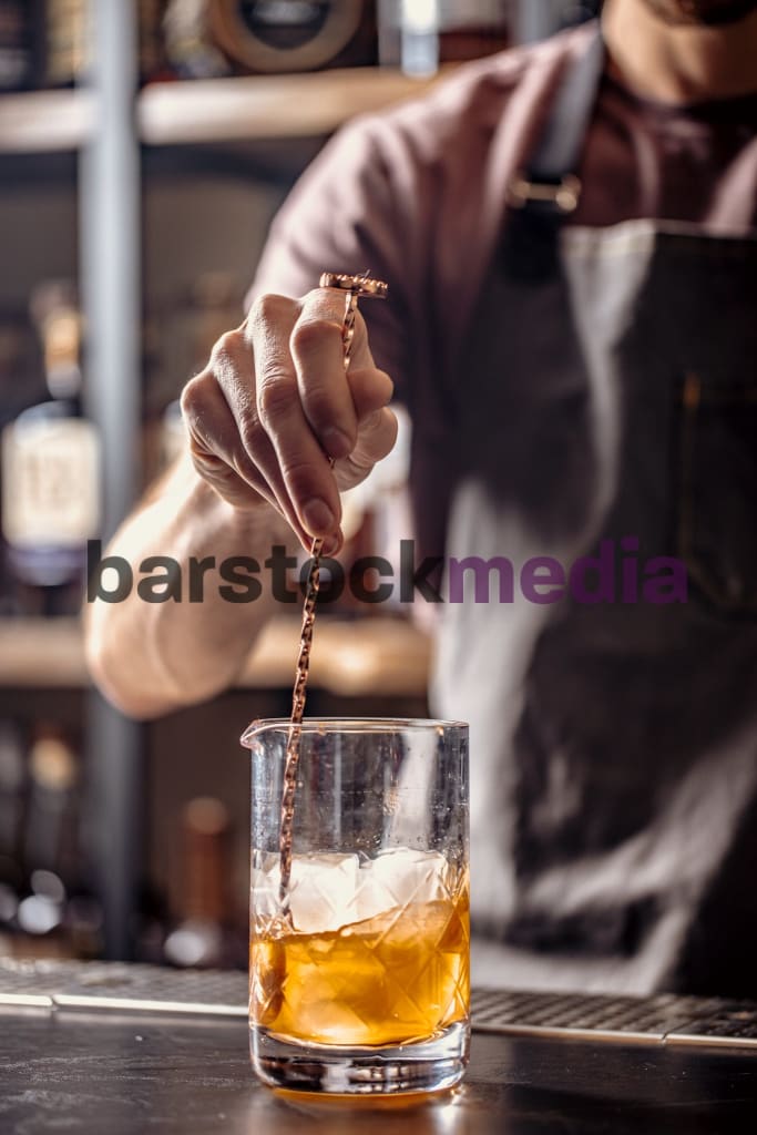 Bartender Stirring Cocktail On Bar Ii